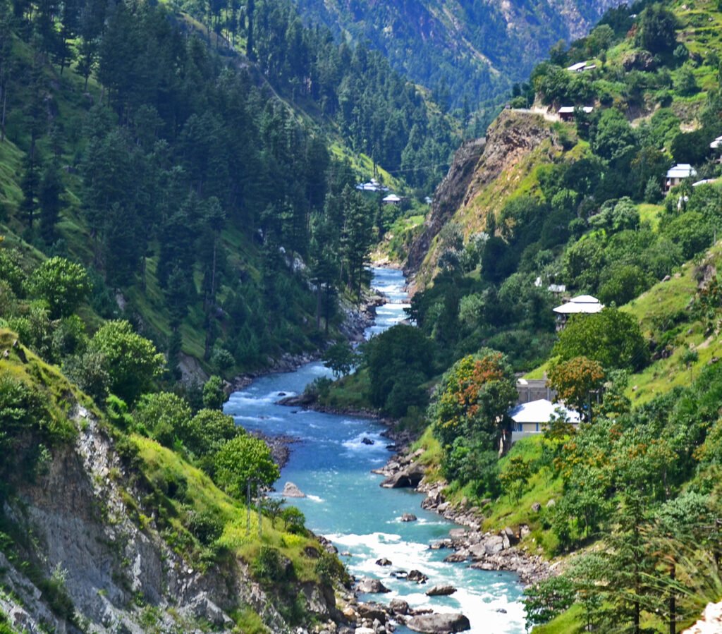 Breathtaking view of Naran Valley, showcasing lush green meadows and towering mountains